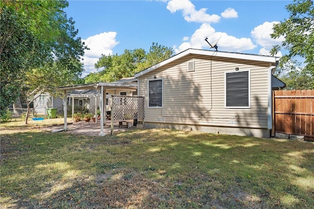 rear view of property with a pergola, a patio area, and a yard