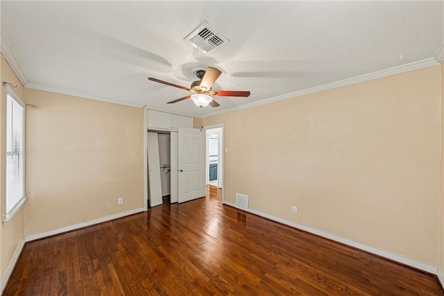 unfurnished bedroom with ornamental molding, ceiling fan, and dark wood-type flooring