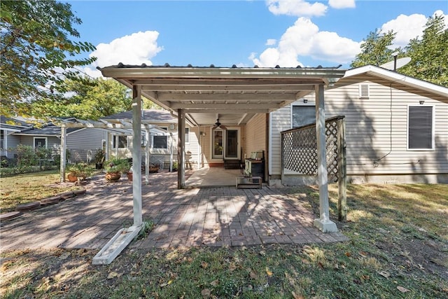 back of house with a lawn, a patio area, and ceiling fan