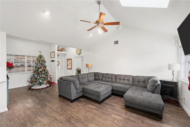 living room featuring a skylight, ceiling fan, high vaulted ceiling, and dark hardwood / wood-style floors