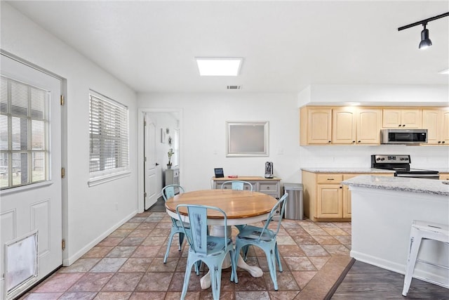 dining area featuring rail lighting