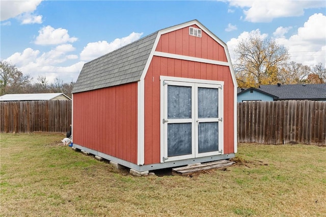 view of outbuilding with a lawn