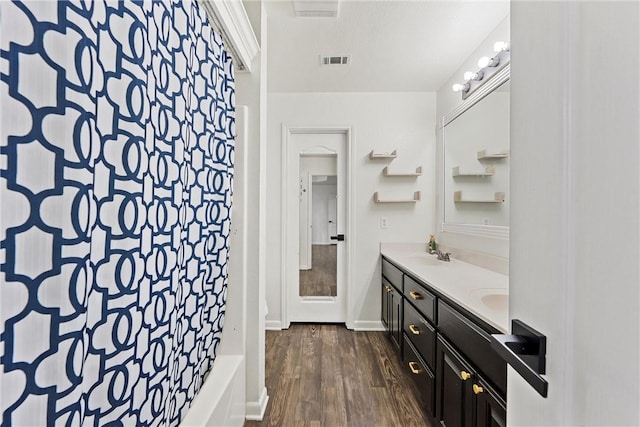 bathroom featuring vanity, wood-type flooring, and shower / tub combo with curtain