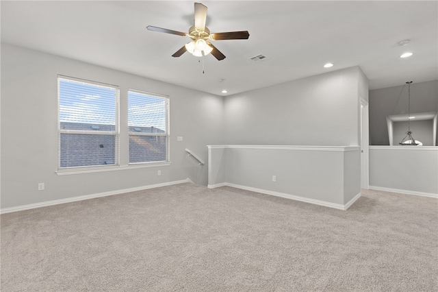 carpeted empty room featuring ceiling fan