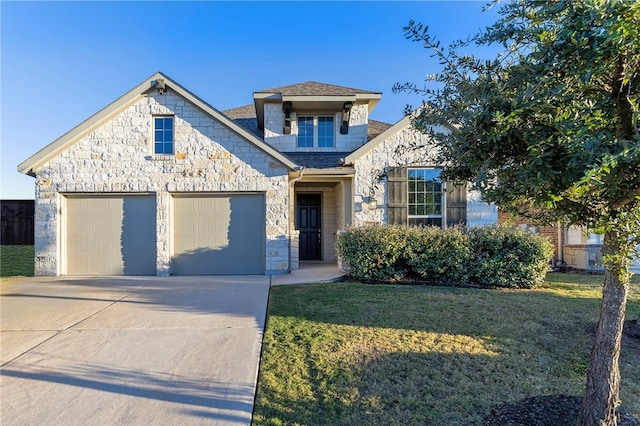 view of front of house featuring a garage and a front lawn