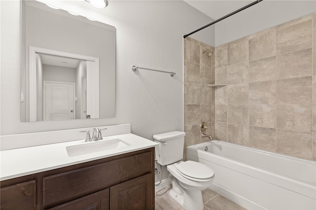 full bathroom featuring vanity, tiled shower / bath combo, toilet, and tile patterned flooring