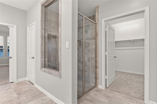 bathroom with tile patterned flooring and a shower with shower door