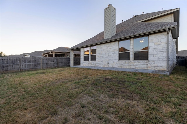 back of house featuring a lawn and cooling unit