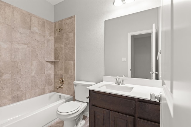 full bathroom with vanity, tiled shower / bath combo, and toilet