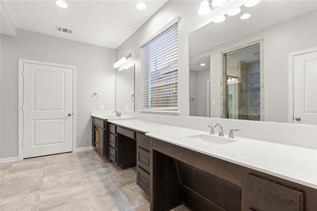 bathroom featuring vanity and a shower with shower door