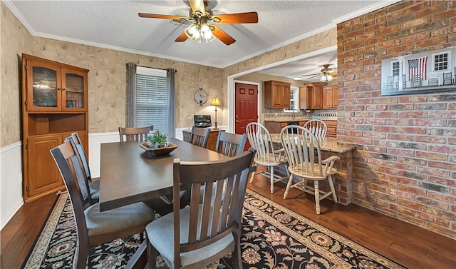 dining space featuring wood-type flooring, a textured ceiling, ceiling fan, and crown molding