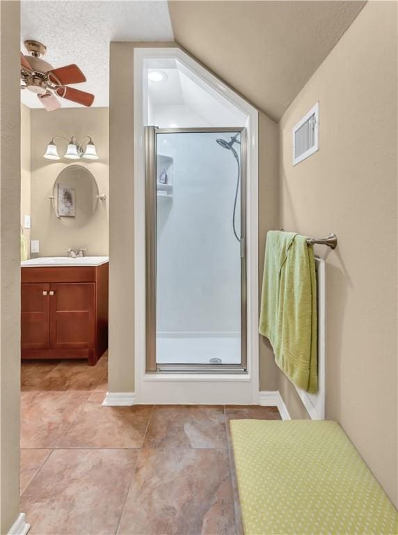 bathroom featuring ceiling fan, tile patterned floors, lofted ceiling, a shower with door, and vanity