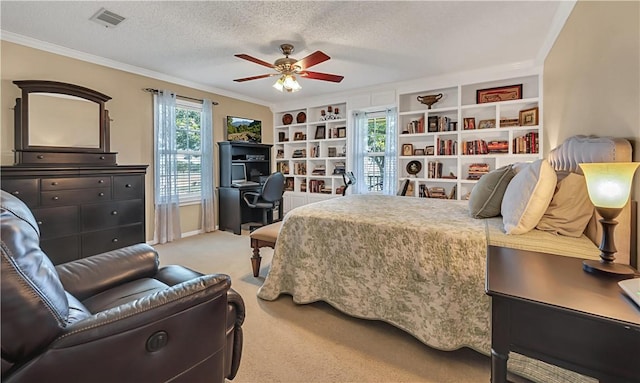 carpeted bedroom featuring a textured ceiling, ceiling fan, and ornamental molding