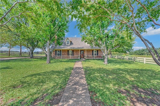 cape cod house with a front lawn and covered porch