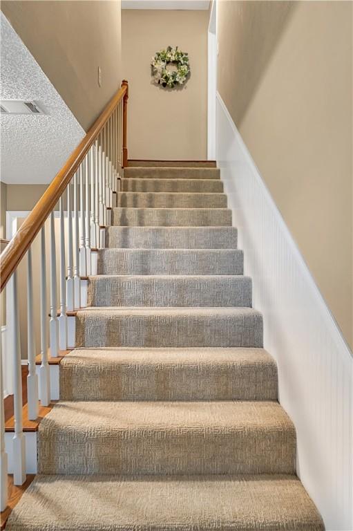 stairway with hardwood / wood-style flooring