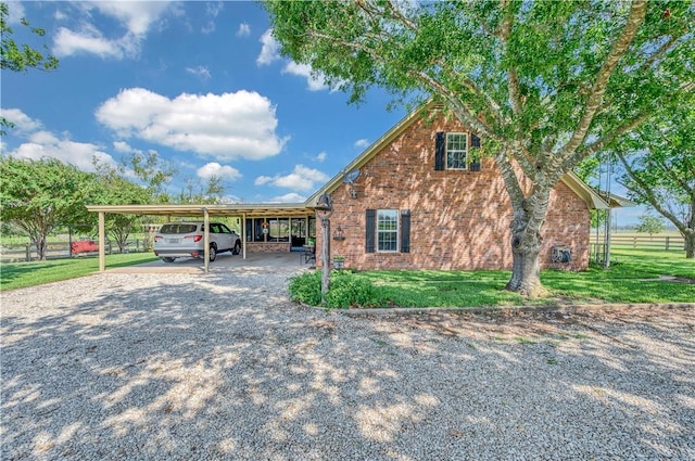 view of side of home featuring a lawn and a carport