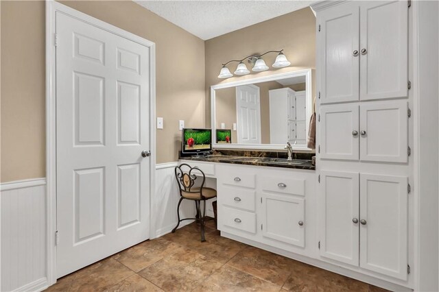 bathroom with vanity and a textured ceiling