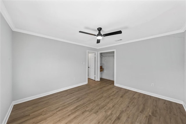 spare room with wood-type flooring, ceiling fan, and crown molding