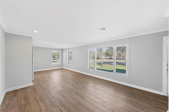 spare room featuring dark hardwood / wood-style floors and ornamental molding