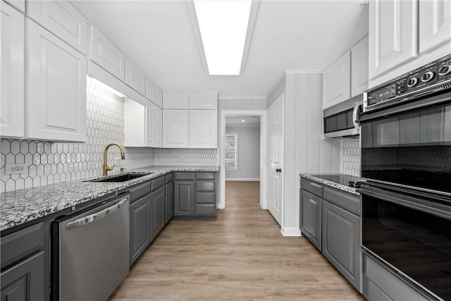 kitchen with white cabinets, stainless steel appliances, gray cabinetry, and sink