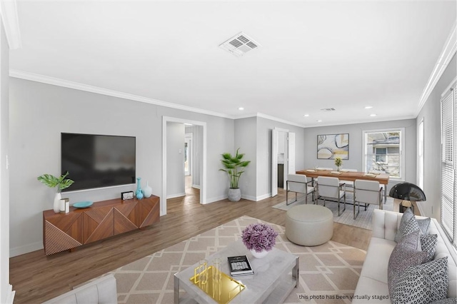 living room with crown molding and hardwood / wood-style flooring