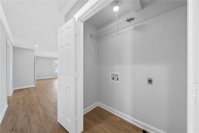 clothes washing area featuring hardwood / wood-style floors, electric dryer hookup, ornamental molding, and hookup for a washing machine