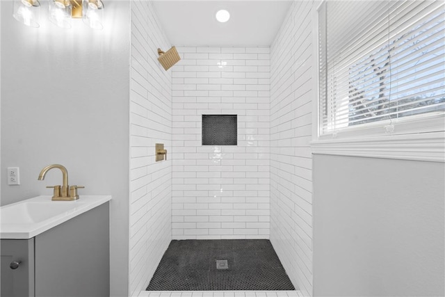 bathroom featuring sink and tiled shower