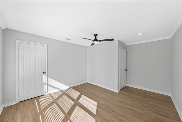 unfurnished room with ceiling fan, wood-type flooring, and ornamental molding