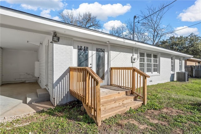 exterior space with a lawn and central AC unit