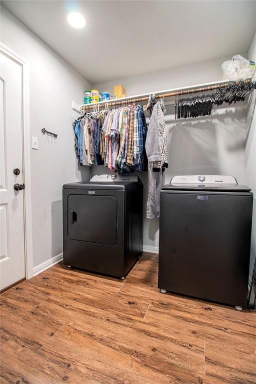 washroom featuring separate washer and dryer and hardwood / wood-style floors