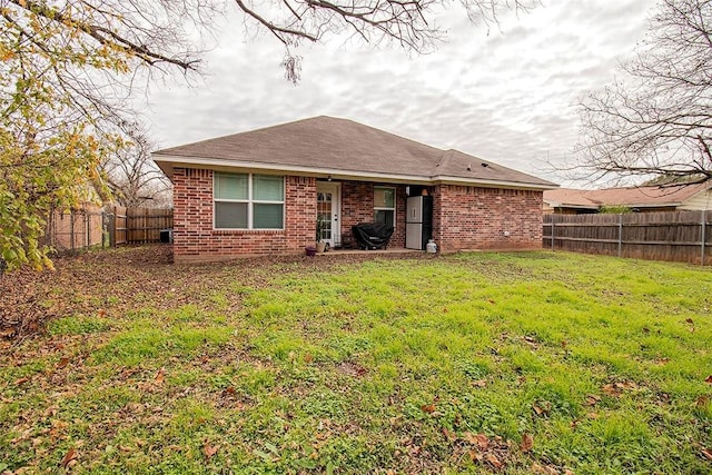 back of house featuring a lawn