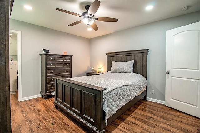 bedroom featuring dark hardwood / wood-style flooring, ensuite bath, and ceiling fan