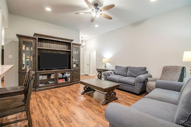 living room featuring ceiling fan and light hardwood / wood-style flooring