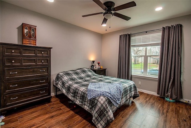 bedroom with dark hardwood / wood-style floors and ceiling fan