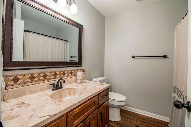 bathroom with tasteful backsplash, a shower with curtain, vanity, hardwood / wood-style flooring, and toilet