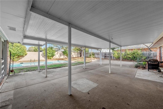 view of patio featuring area for grilling and a fenced in pool