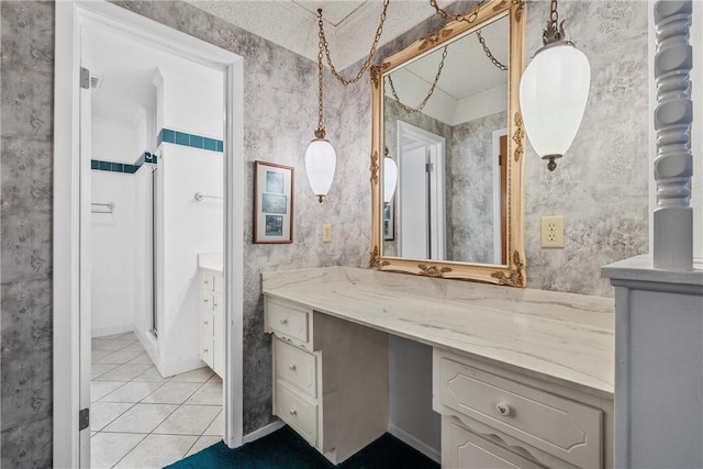 bathroom with tile patterned floors, vanity, and a shower