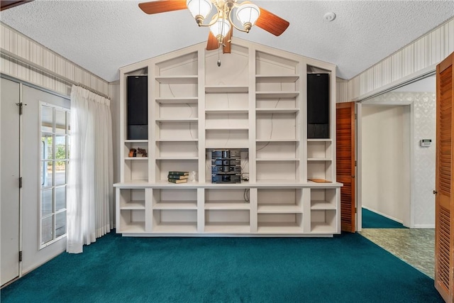 unfurnished living room with dark carpet, a textured ceiling, and vaulted ceiling