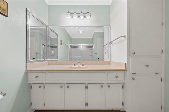 bathroom featuring vanity, ornamental molding, and walk in shower