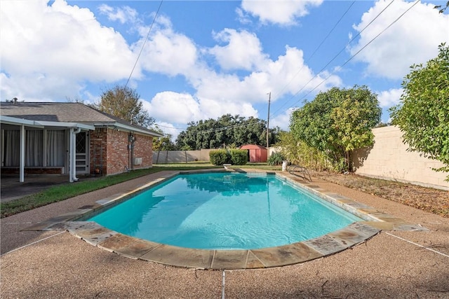 view of swimming pool with a diving board