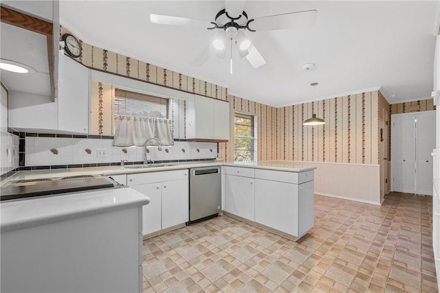 kitchen featuring white cabinetry, dishwasher, pendant lighting, and sink