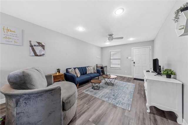 living room featuring ceiling fan and wood-type flooring