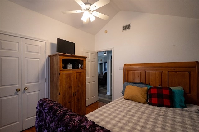 bedroom with vaulted ceiling, a closet, ceiling fan, and dark hardwood / wood-style flooring