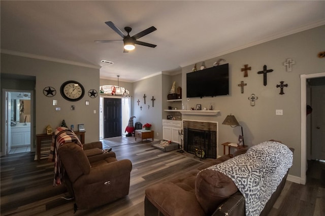 living room featuring ceiling fan, ornamental molding, and wood-type flooring