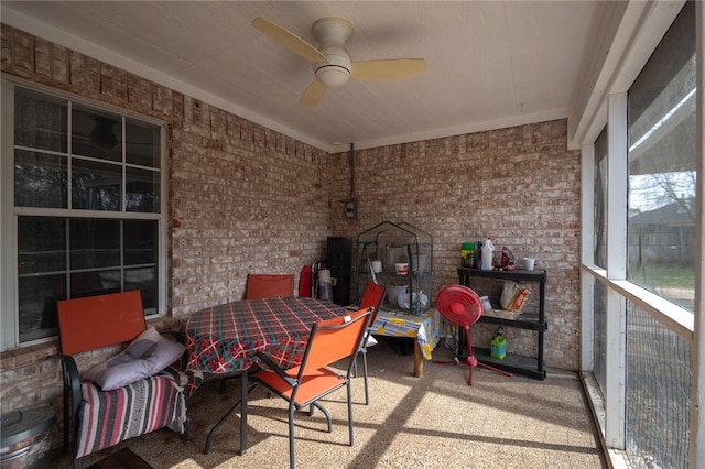 sunroom featuring ceiling fan