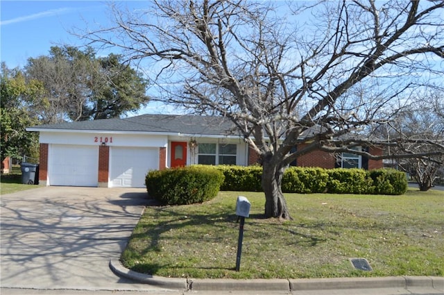 single story home featuring a front lawn and a garage