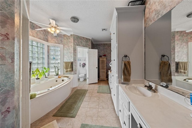 bathroom featuring ornamental molding, vanity, a textured ceiling, ceiling fan, and a tub