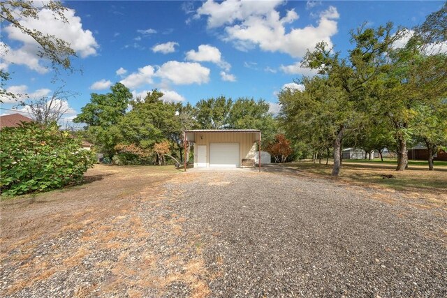 view of front of house featuring an outdoor structure and a garage