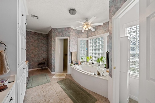 bathroom with tile patterned floors, crown molding, a washtub, and a textured ceiling