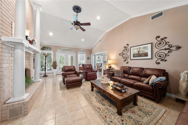 tiled living room with a fireplace, a textured ceiling, high vaulted ceiling, and ceiling fan